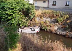 Auto v řece a na střeše skončila v úterý večer v Chocni. Foto: HZS Pardubického kraje