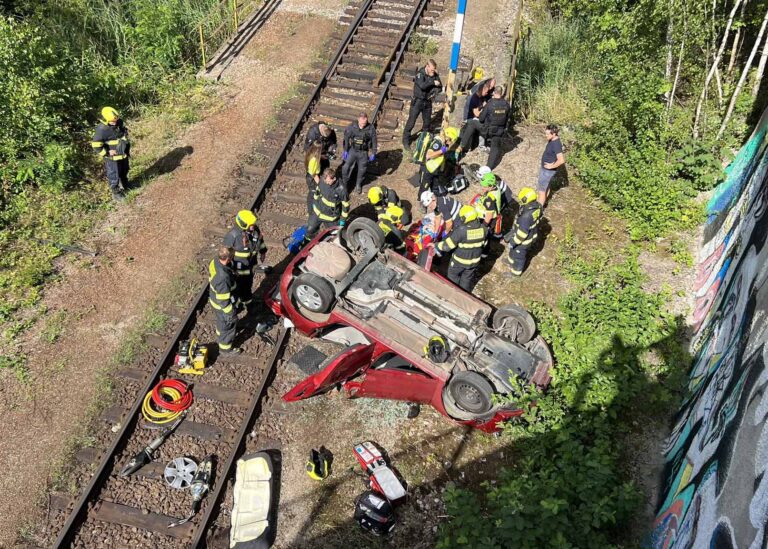 Auto v Černokostelecké ulici v Praze vyletělo z mostu a zřítilo se na koleje. Foto: HZS Praha